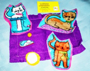 Felt cats set; 3 cats; mouse; bowl of milk; blanket. Cats were cut out of printed fleece then machine sewn onto felt backing.