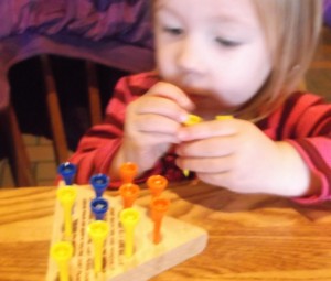 Small children enjoy Peg Board games. They don't have to play by any rules yet.
