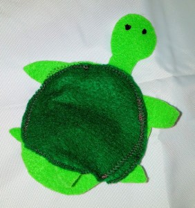This 2 toned green turtle finger puppet can hide it's head inside its felt shell.